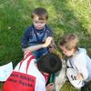 Child eats string whilst others look on!